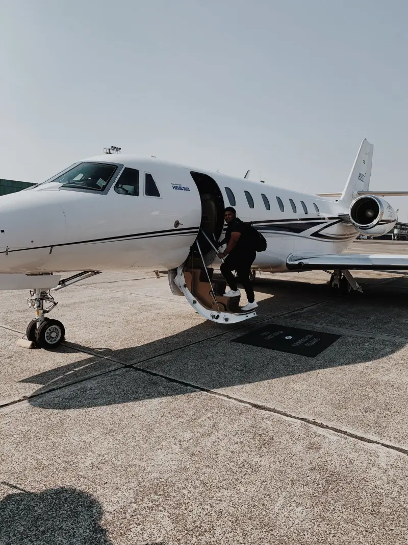 Passenger climbing the airstair of a light business jet