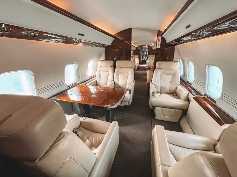 Placeholder photo of cream leather club seats in a large cabin jet
