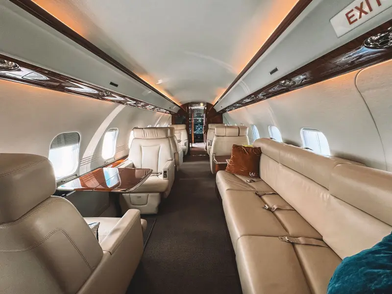 Private jet cabin with a long leather divan along one side