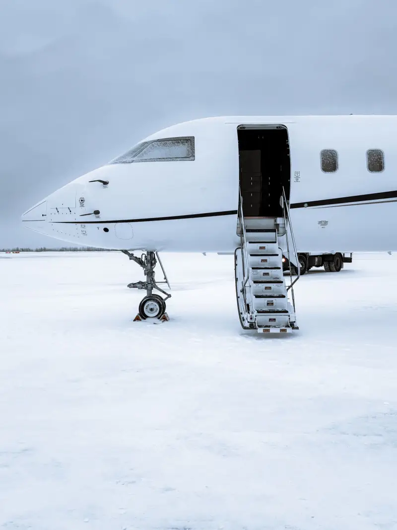 Placeholder photo of a private jet parked on snow with its airstair lowered